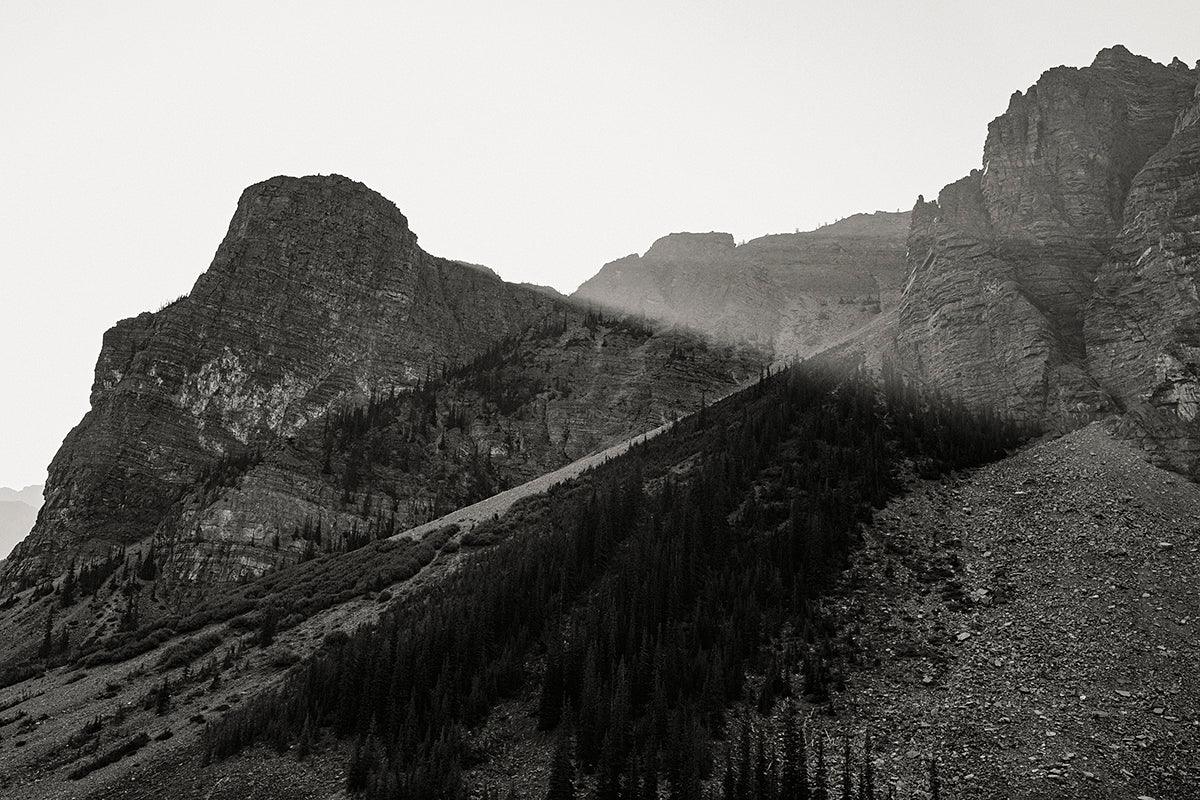 The morning sun peeks over the ridge at Moraine Lake, Banff National Park - Walloy